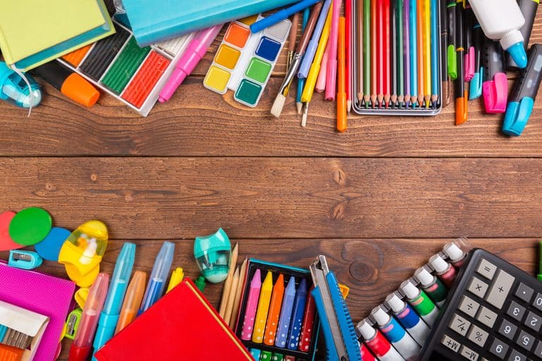 desk cluttered with office supplies